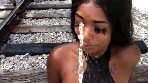 Ebony slut has an outdoor golden shower